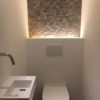 gorge lumineuse dans toilette avec effet lumineux sur carrelage mural.